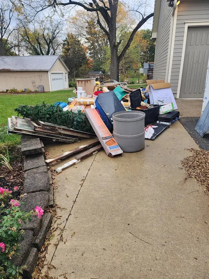 Dumpster being loaded with debris for 3 Yard Dumpster Rental in Cedarhurst